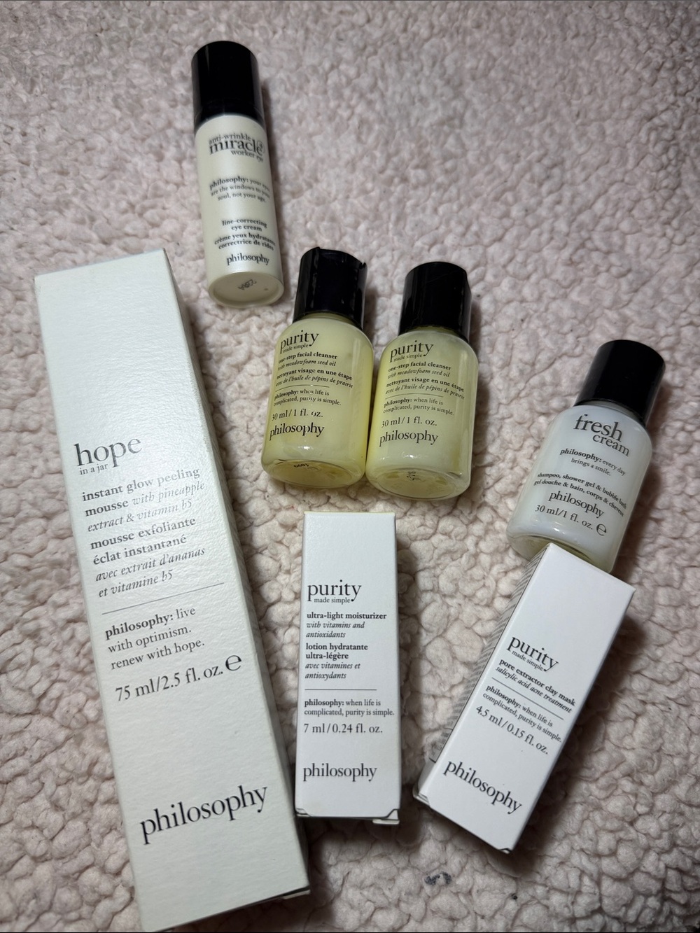 Philosophy instant glow peeling mousse, eye cream, travel skincare minis & bag.